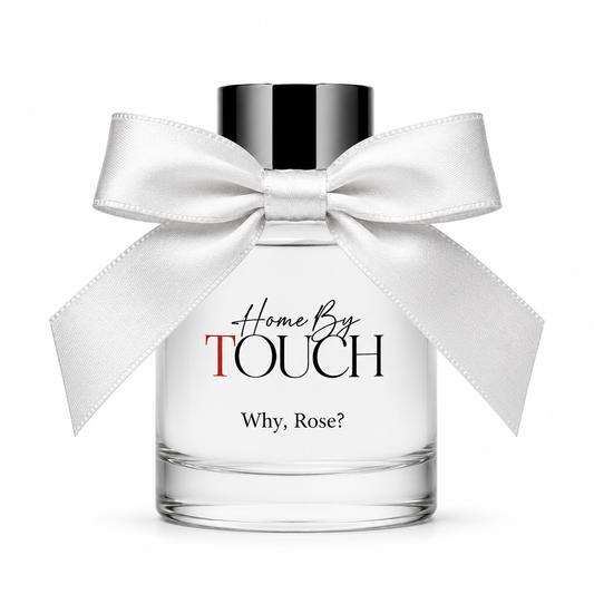 Perfume bottle with a white bow labeled 'Home By Touch Why, Rose?' on a white background