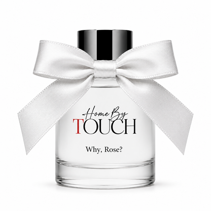 Perfume bottle with a white bow labeled 'Home By Touch Why, Rose?' on a white background