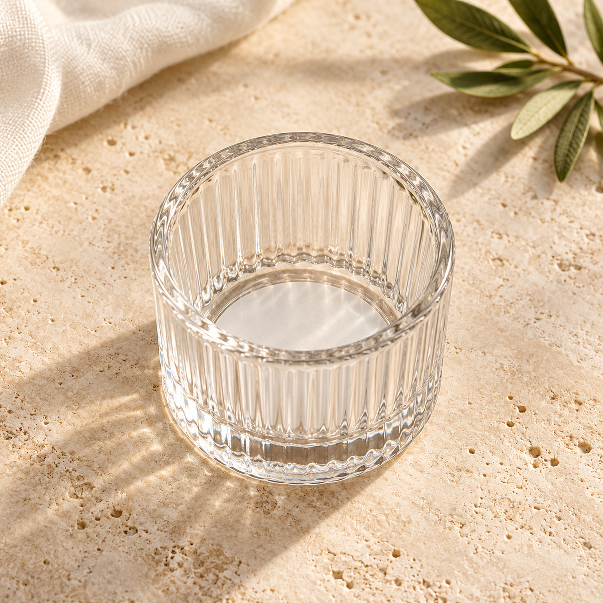 Top view of the empty ribbed glass tea light holder showing its open interior.