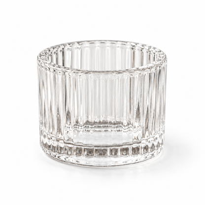 Clear ribbed glass tea light holder, shown empty on a white background.